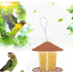 Hanging bird feeder with automatic seed dispenser